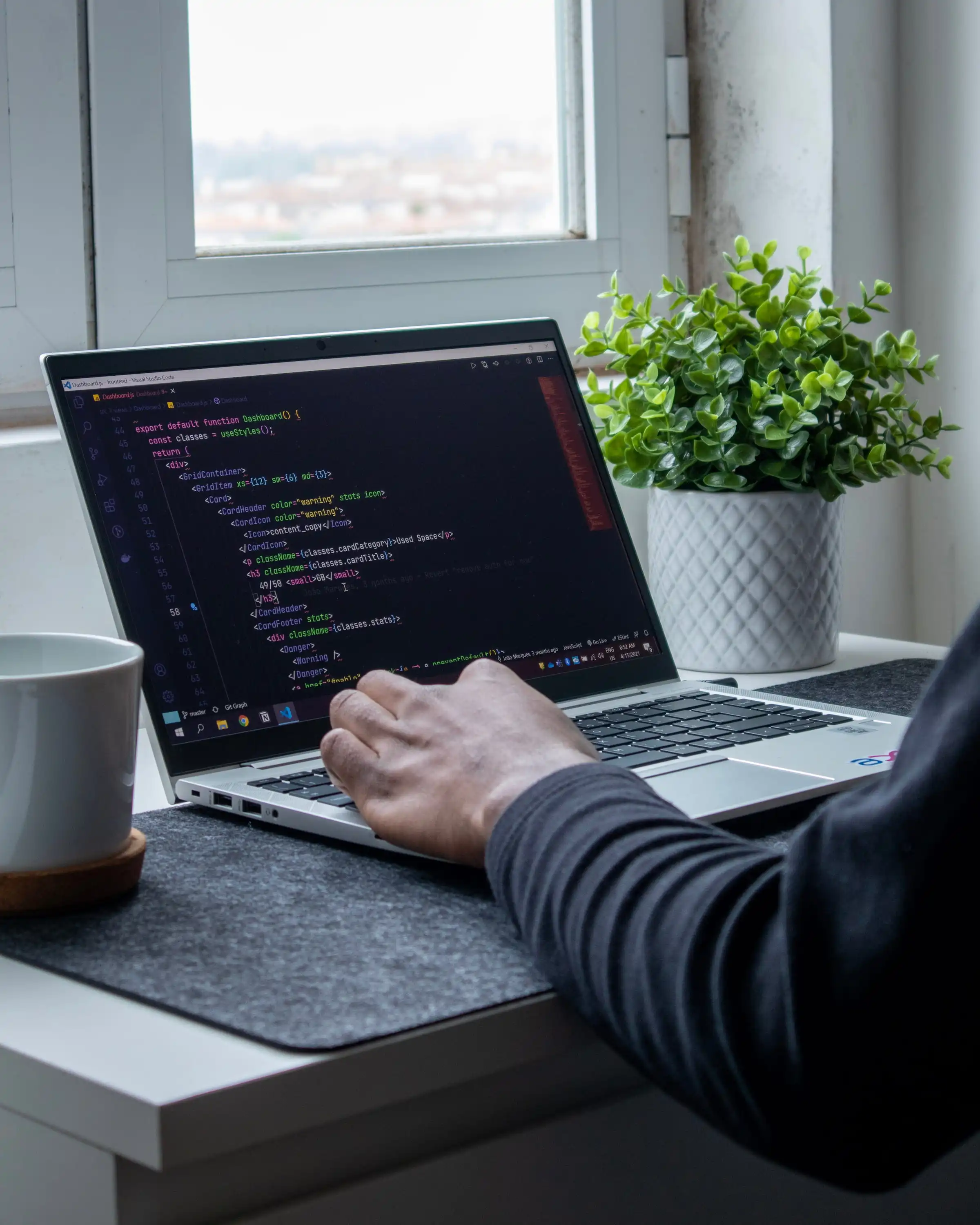 Someone working on a laptop on a desk